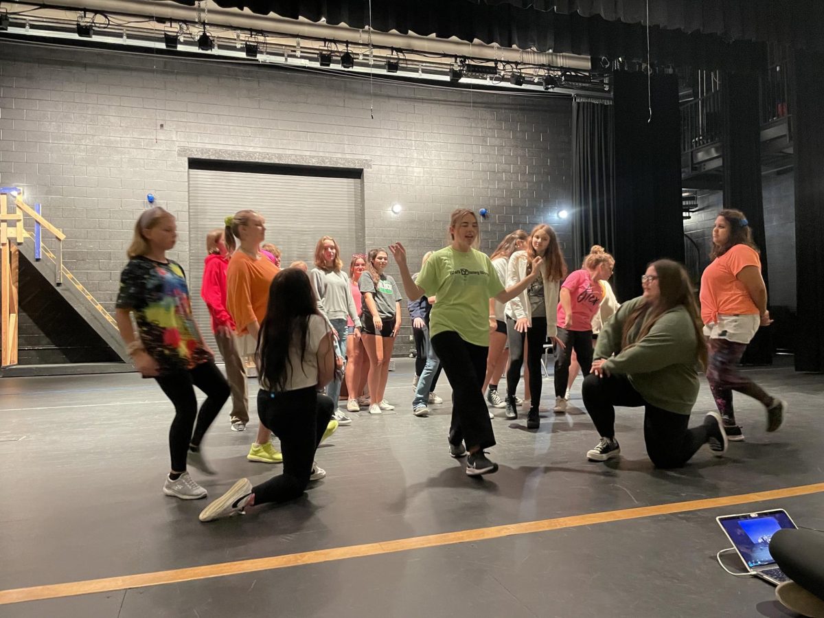 The cast and ensemble of Mary Poppins performing Supercalifragilisticexpialidocious