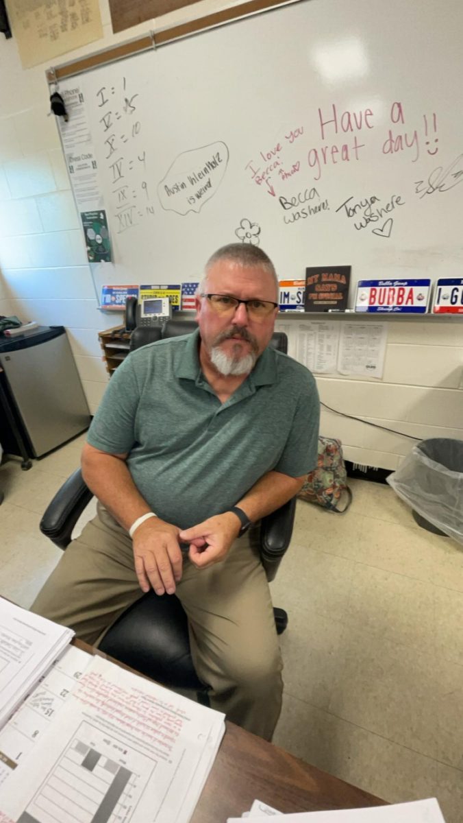 Mr. Sowders sitting in his classroom