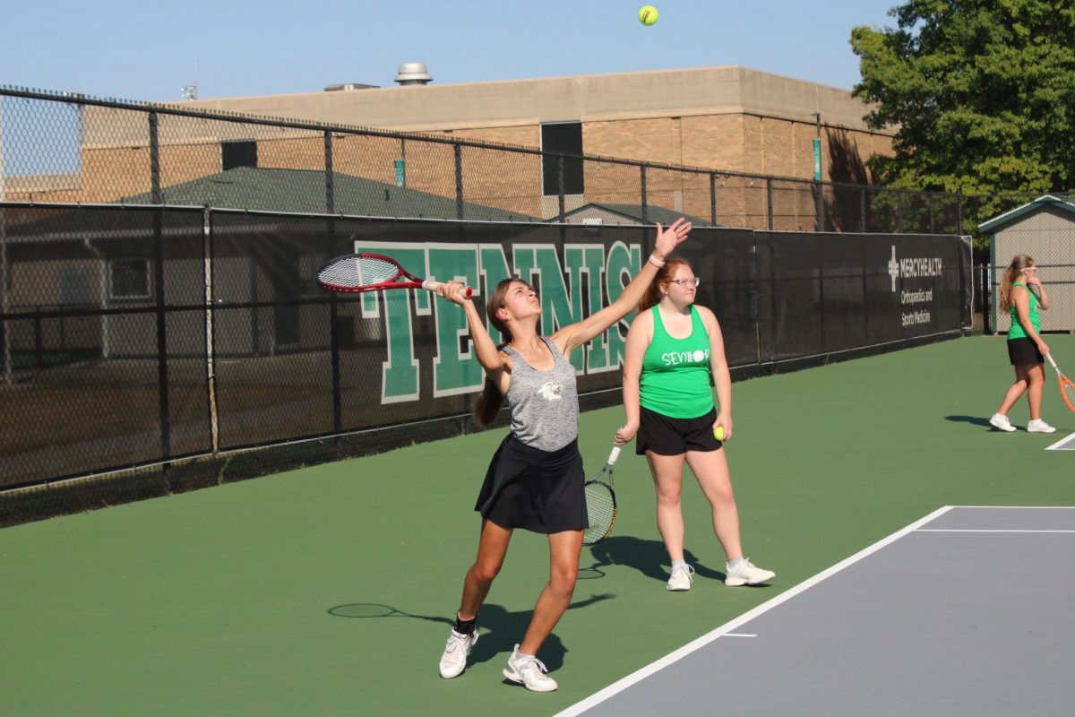 Emily Benight serving during warmups.