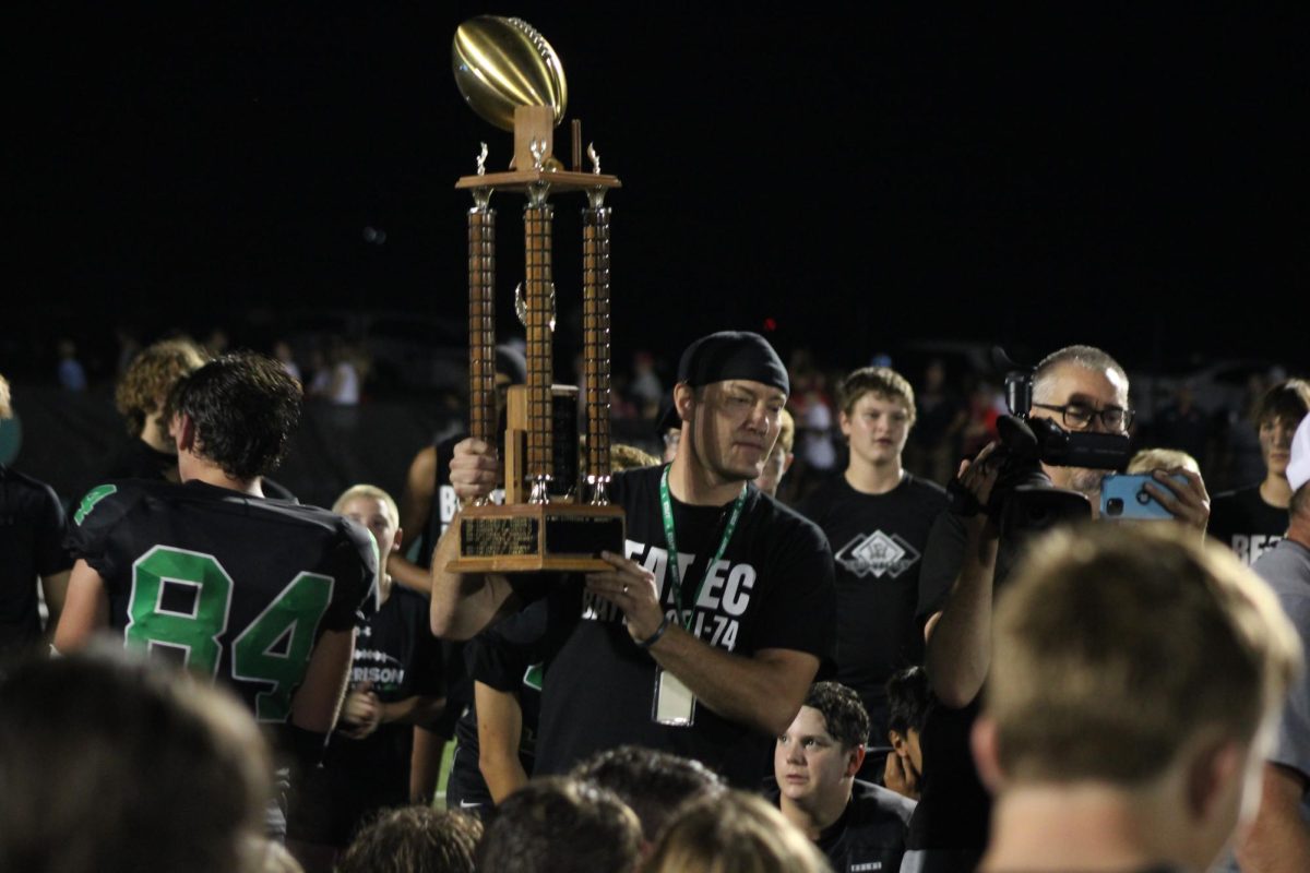 Mr. Meibers holding trophy after victory against East Central.