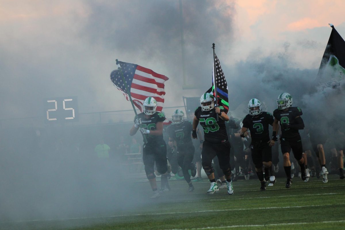 Players running through tent and smoke at H vs EC Game.