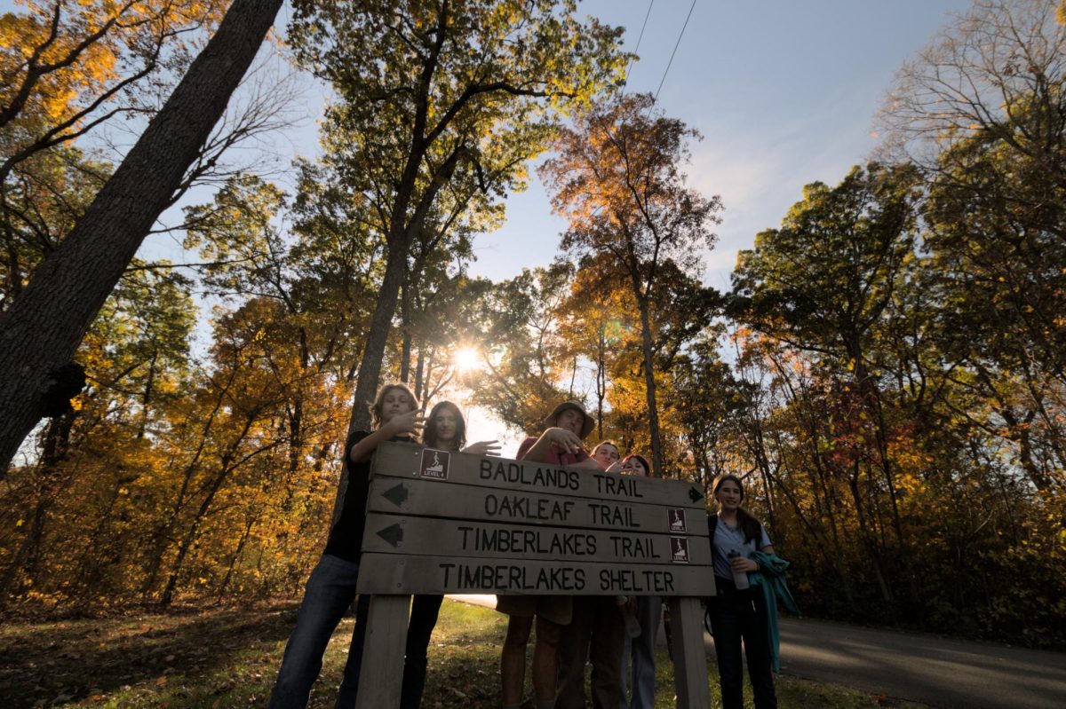 Ecology Club standing behind the trail sign with Mr. Zuerick 