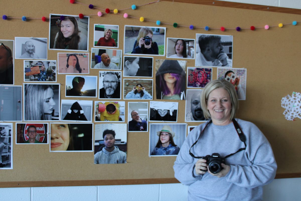 Ms. Keller next to her students' projects.