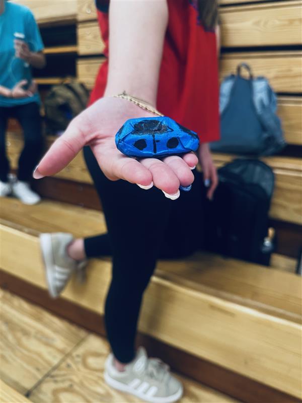 Olivia Long with the Hot Wheels car that she made 