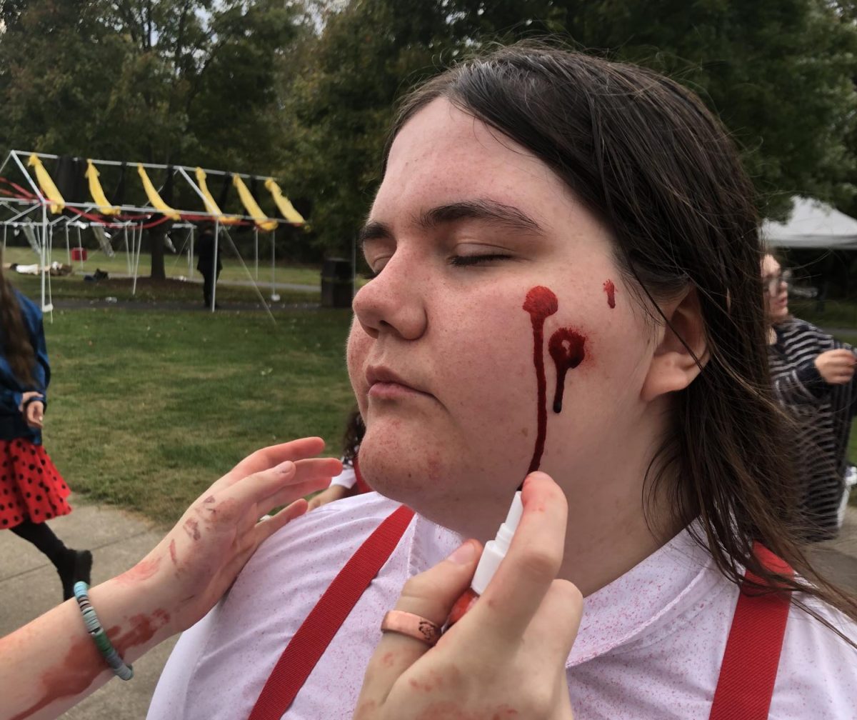 Kora Doolan getting fake blood splattered on her face
