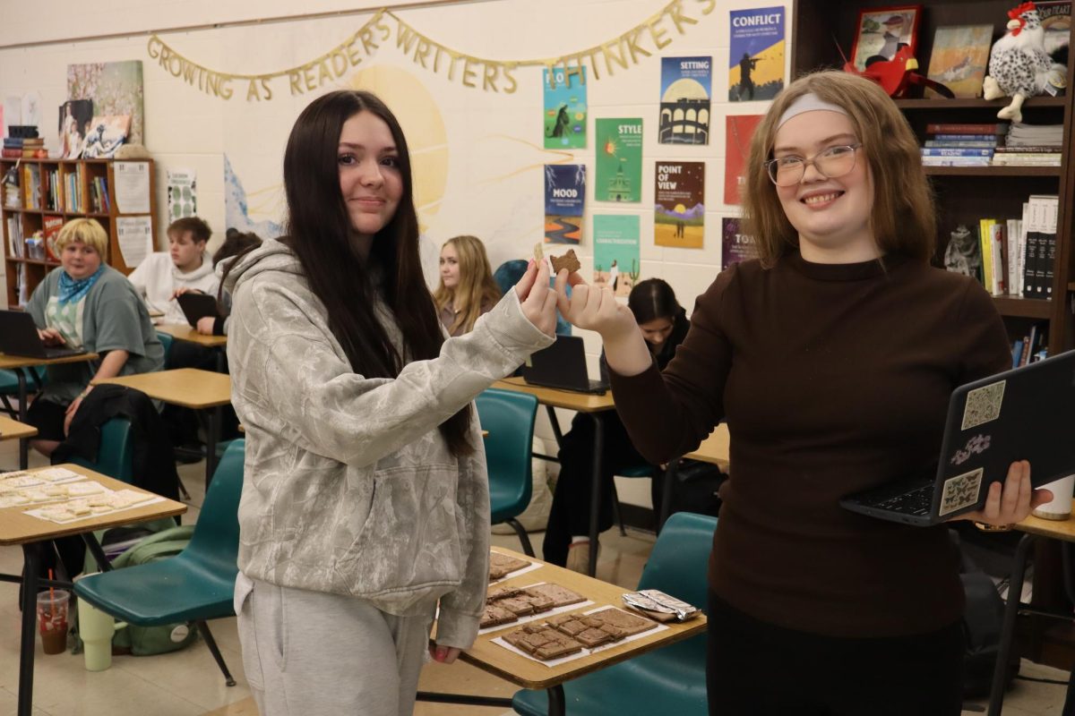 Chloe Redden and Bailey Ramsey toast with their toaster pastries during our journalism taste test.