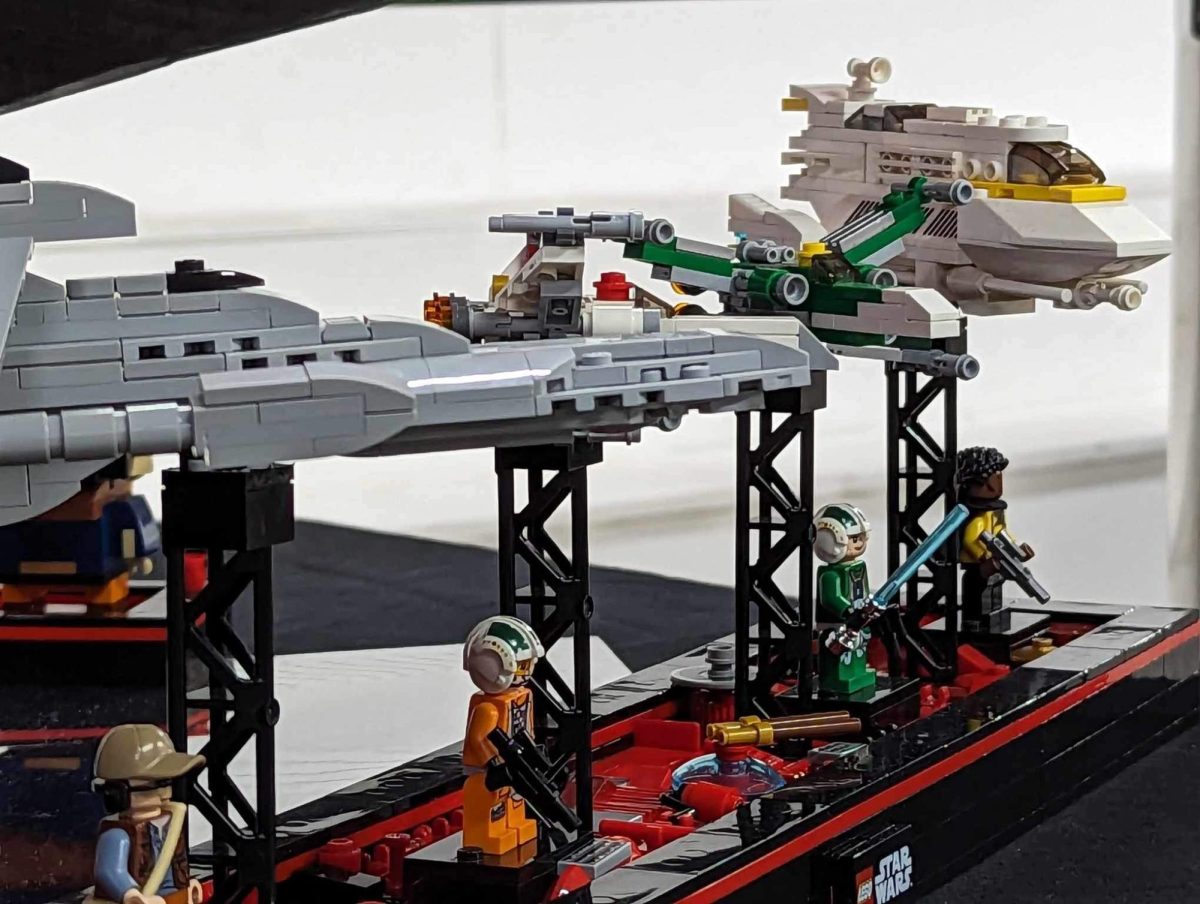 Minifigures and small ships on side of Errant Venture