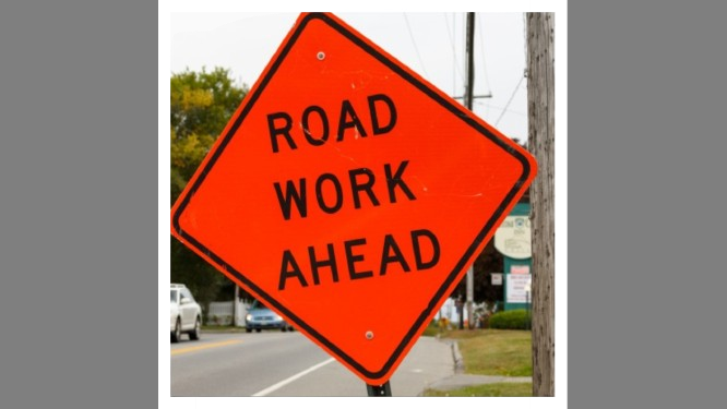A picture of a road work ahead sign.